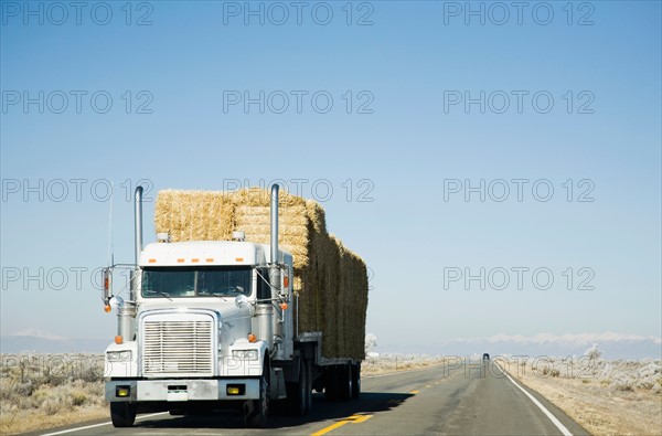 Truck hauling hay on rural road