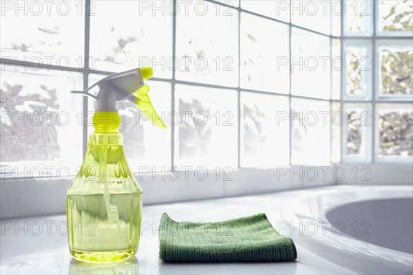 Cleaning supplies in front of glass brick wall