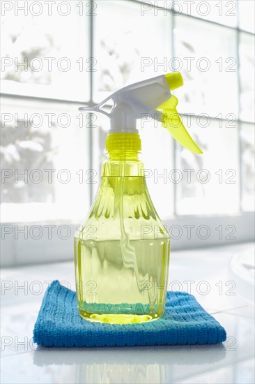 Cleaning supplies in front of glass brick wall