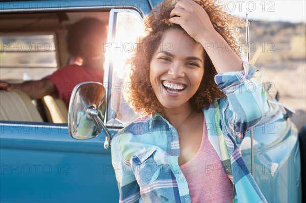 Woman in foreground with friend during their road trip