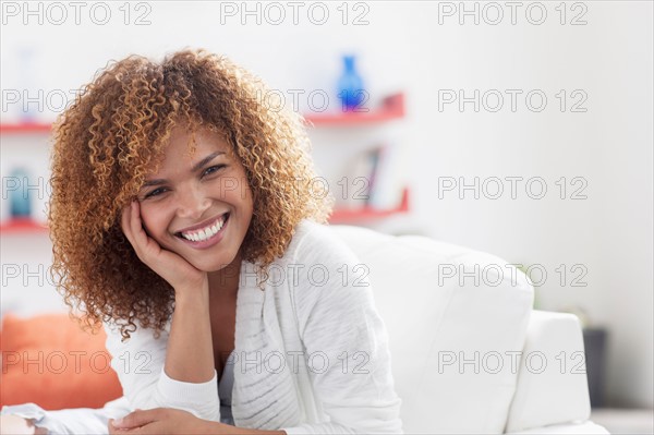 Portrait of mid adult woman relaxing at home