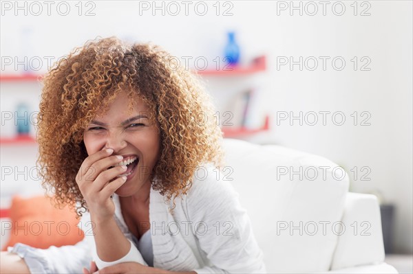 Portrait of mid adult woman relaxing at home