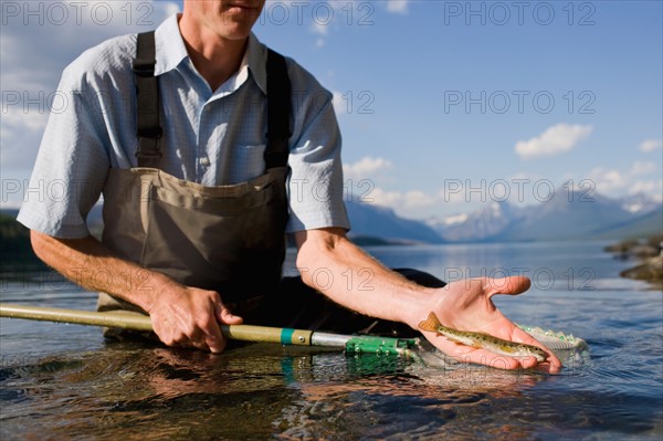 Man holding juvenile western cutthroat trout