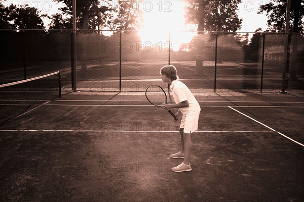 Boy playing tennis