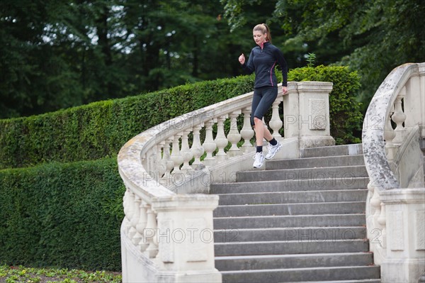 Young woman running down stairs