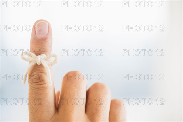 Hand with reminder bow on finger.