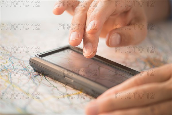 Close-up of hand using gps system.