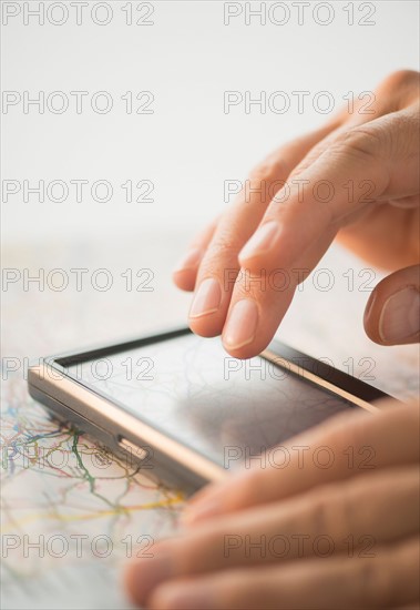 Close-up of hand using gps system.