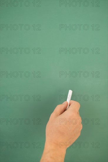 Hand writing on chalkboard.