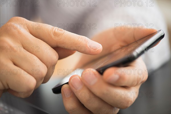 Close-up of hands using smartphone.