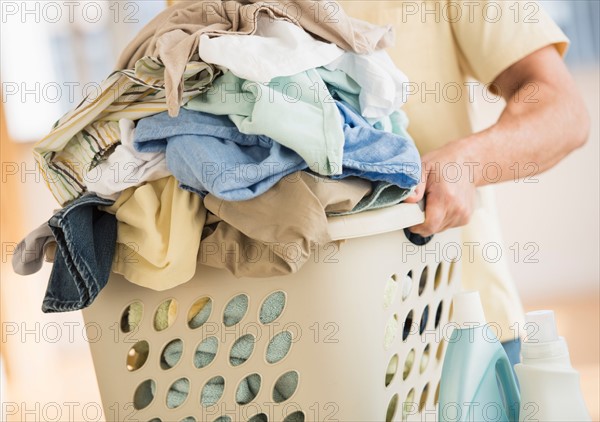 Man carrying laundry basket.