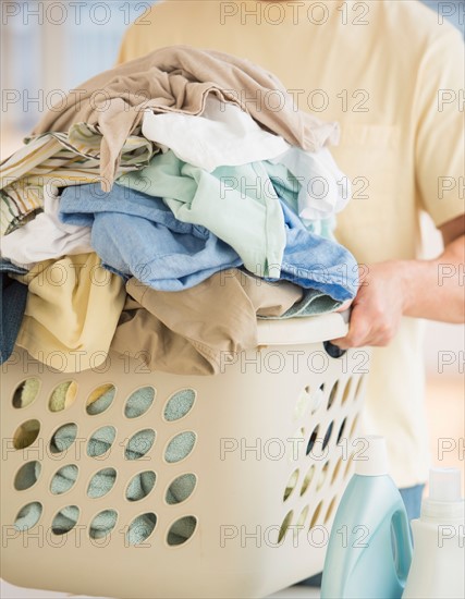 Man carrying laundry basket.