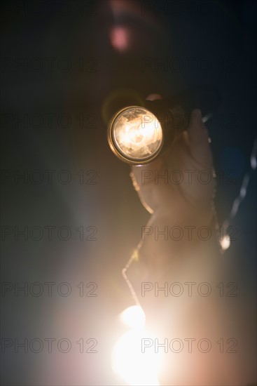 Hand holding flashlight.