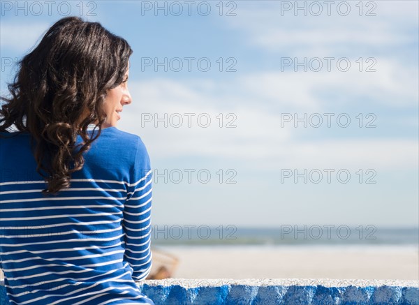 Woman relaxing on beach. Photo : Jamie Grill