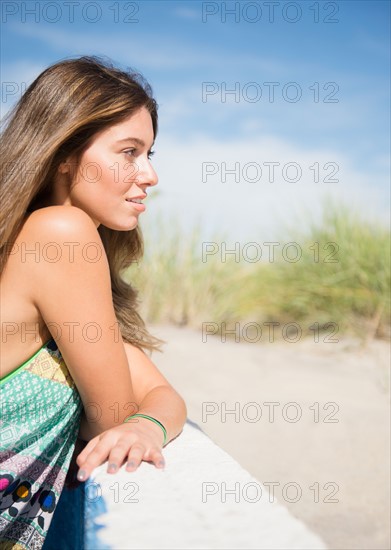 Woman relaxing on beach. Photo : Jamie Grill