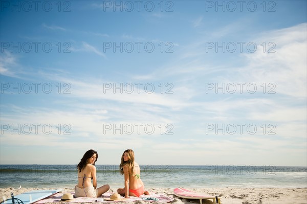 Two women relaxing on beach. Photo: Jamie Grill