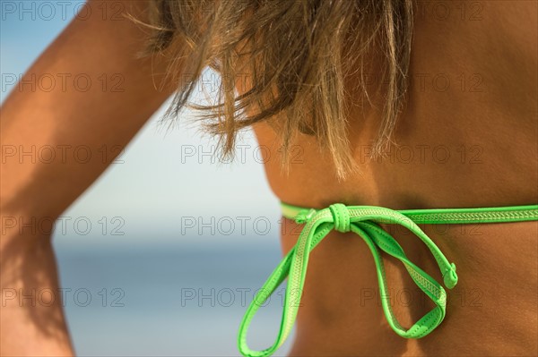 Woman sunbathing at beach. Photo : Jamie Grill