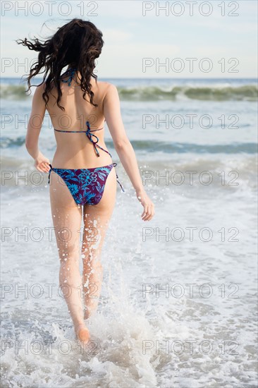 Woman wading in sea. Photo : Jamie Grill