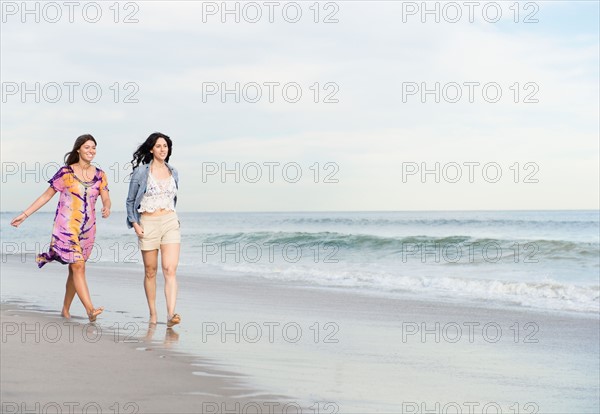 Two women walking on beach. Photo : Jamie Grill