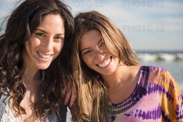 Portrait of two young women on beach. Photo : Jamie Grill