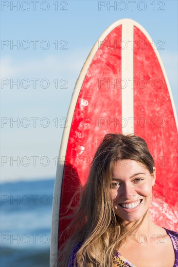 Portrait of woman with surfboard. Photo : Jamie Grill