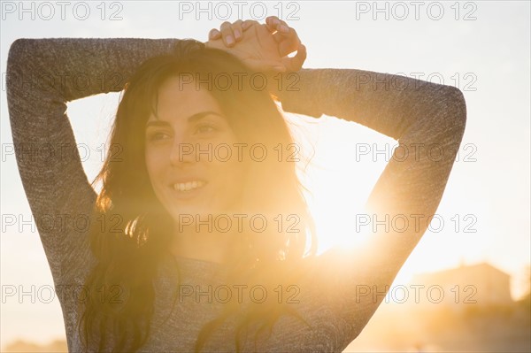 Smiling woman at sunset. Photo : Jamie Grill