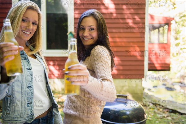 Two women enjoying barbecue. Photo : Jamie Grill