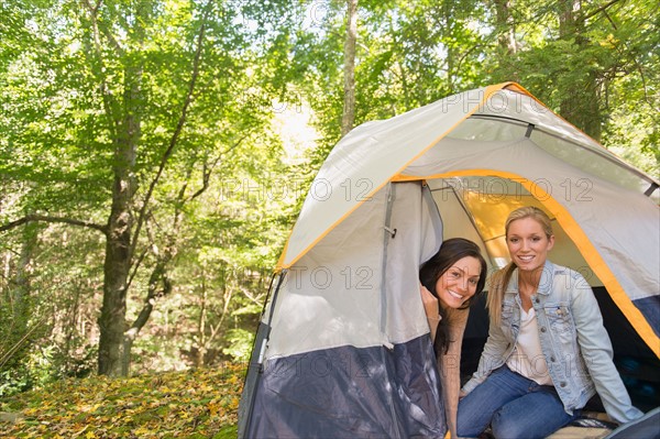 Two women sitting in tent in forest. Photo : Jamie Grill