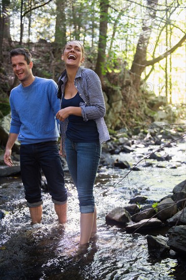 Couple wading in stream. Photo : Jamie Grill