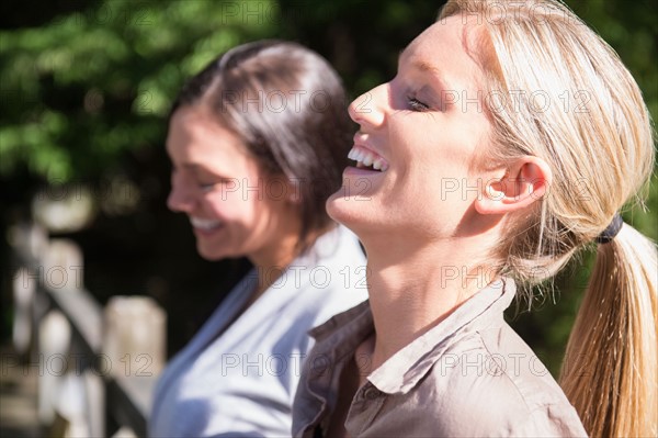 Two women smiling outdoors. Photo : Jamie Grill