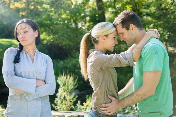 Couple and unhappy woman in forest. Photo: Jamie Grill