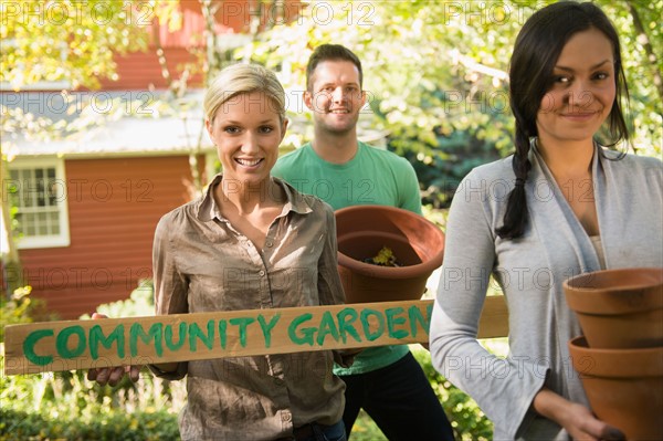 Three friends preparing community garden. Photo : Jamie Grill