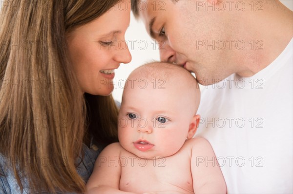 Portrait of parents with baby boy (2-5 months). Photo: Jamie Grill
