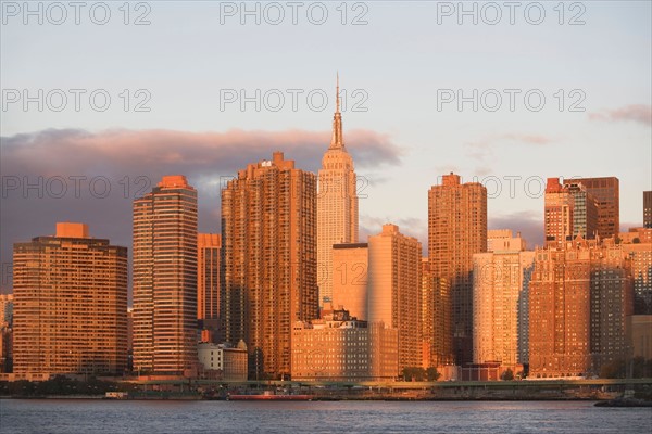 Skyline with Empire State Building at sunset. Photo : Alan Schein