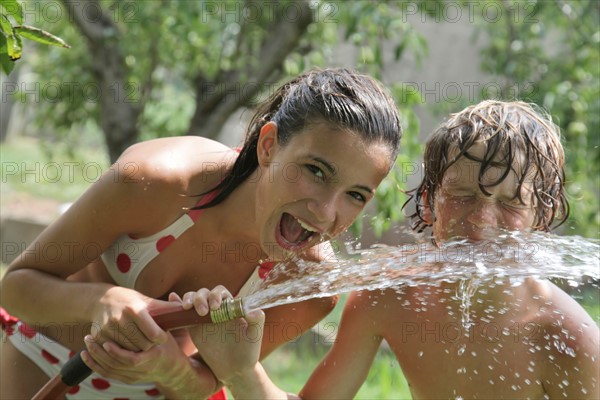 Boy (10-11) drinking from water hose in summer. Photo: pauline st.denis