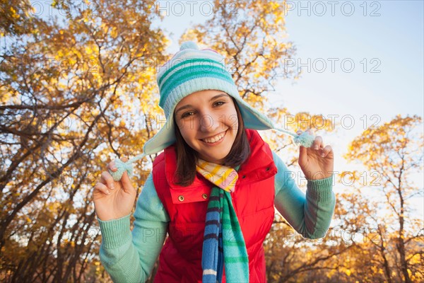 Portrait of smiling young woman in autumn forest. Photo : Mike Kemp