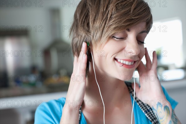 Portrait of young woman listening music. Photo: Dan Bannister