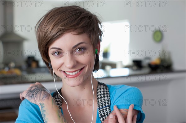Portrait of young woman listening music. Photo: Dan Bannister