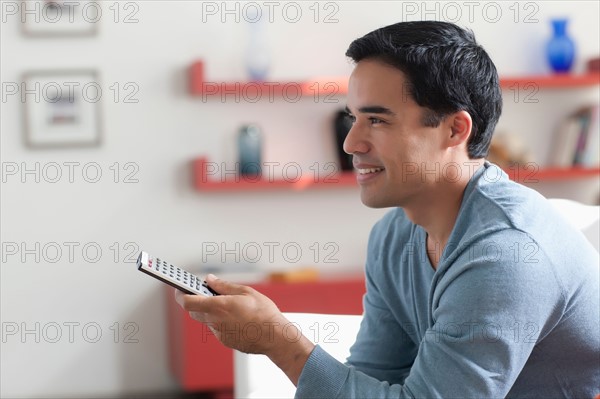 Man watching tv in living room. Photo : Dan Bannister