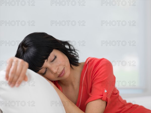 Young woman resting on sofa. Photo : Dan Bannister