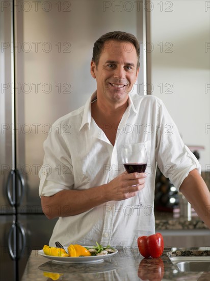 Portrait of mature man with wine glass. Photo : Dan Bannister