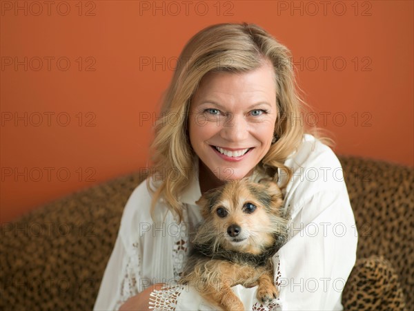 Mature woman playing with dog. Photo: Dan Bannister