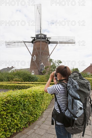 Woman photographing windmill. Photo: Jan Scherders