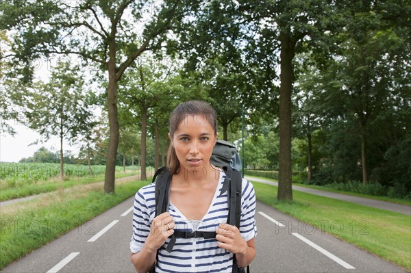 Portrait of young woman with backpack. Photo : Jan Scherders