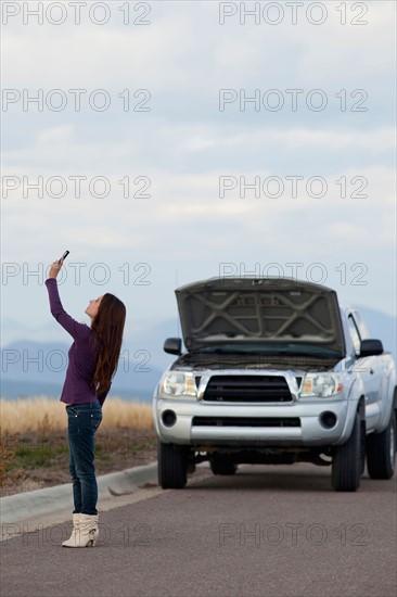 Woman calling for assistance after vehicle breakdown. Photo : Noah Clayton