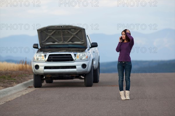 Woman calling for assistance after vehicle breakdown. Photo : Noah Clayton