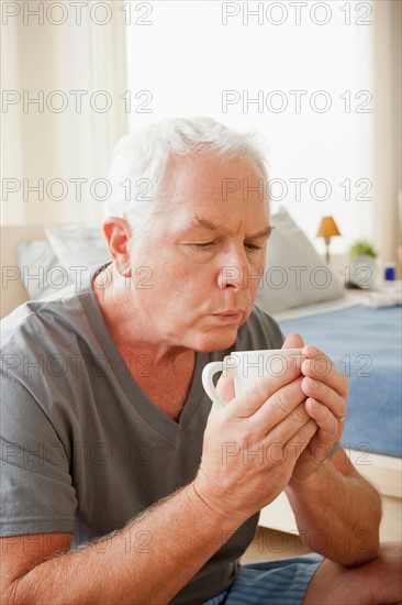Senior man holding mug. Photo: Rob Lewine