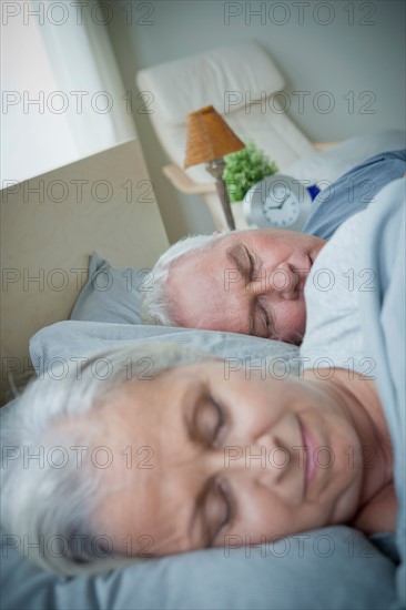 Senior couple sleeping in bed. Photo : Rob Lewine