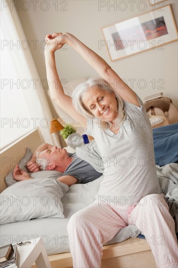 Senior woman stretching after waking up. Photo: Rob Lewine