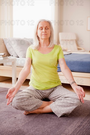 Senior woman practicing yoga. Photo : Rob Lewine